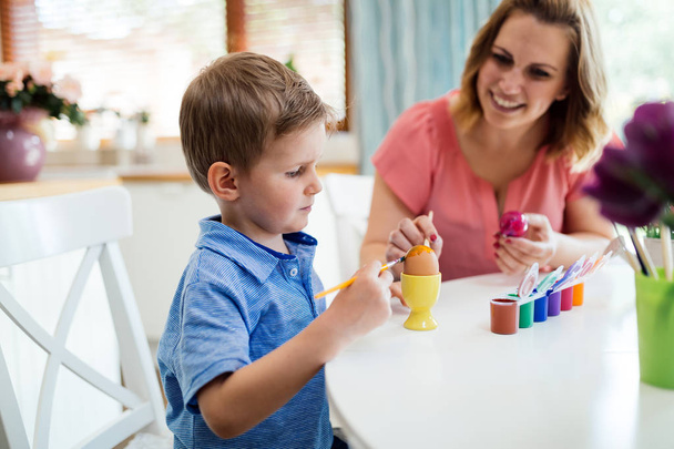 Family, mother and her son having fun paint and decorate eggs for holiday - Foto, Imagem