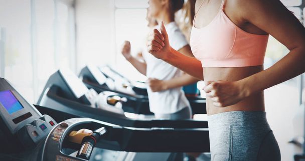 Picture of people doing cardio training on treadmill in gym - Foto, imagen