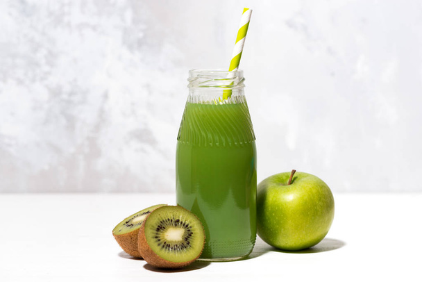 green juice of kiwi and apple in a bottle, closeup - Foto, imagen