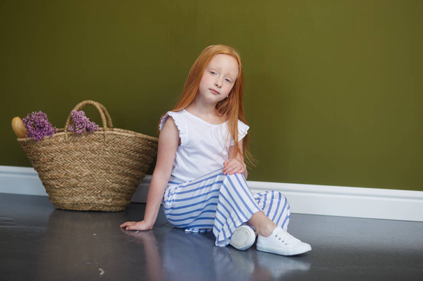 Young red-haired girl with long beautiful hair and big blue eyes - Photo, Image