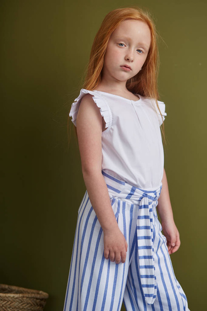 Young red-haired girl with long beautiful hair and big blue eyes - Foto, immagini
