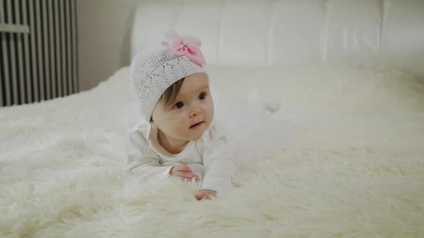 Beautiful little girl is lying on the white bed. - Footage, Video