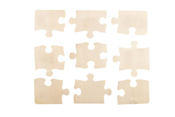 Pieces of wooden jigsaw puzzle isolated on white background. Top view. - Photo, Image