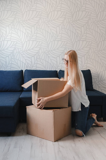 Photo of young blonde with cardboard box - Fotó, kép