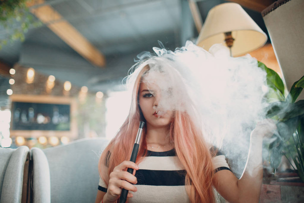 Young beautiful female smoking hookah. Smoke shisha hookah concept. - Zdjęcie, obraz