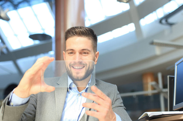 Future concept. Businessman holds futuristic transparent smart phone. - Photo, Image