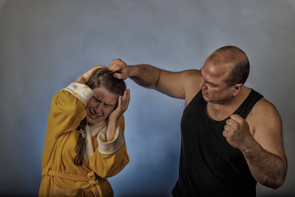 Husband beats his wife with his fist, social problems in the family, quarrel, divorce. - Photo, Image