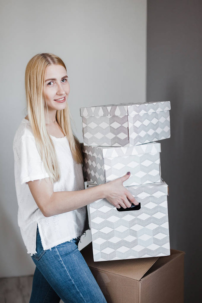 Photo of young blonde with cardboard box - Zdjęcie, obraz