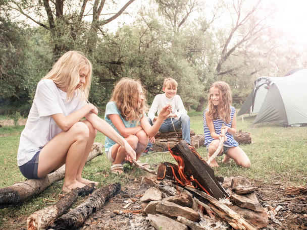 Teen in the camp by the fire - Foto, Imagen