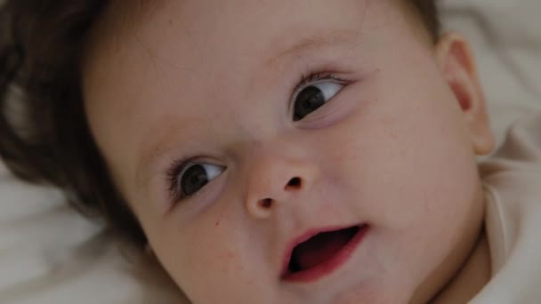 Beautiful little girl woke up and smiles at the camera - Кадри, відео