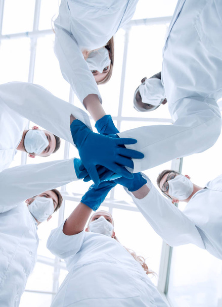 Doctors and nurses in a medical team stacking hands - Foto, Imagen