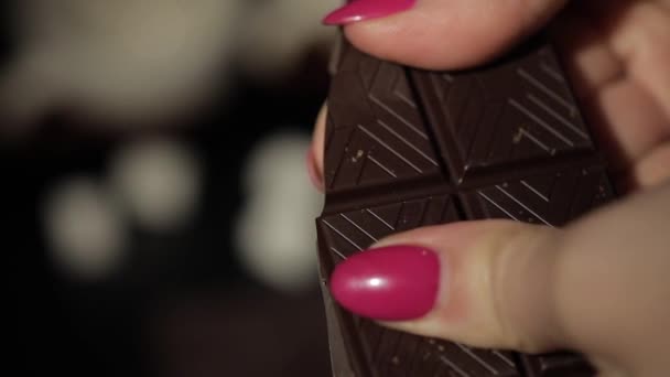 Mulher quebra barra de chocolate preto. Close-up. Movimento lento
 - Filmagem, Vídeo