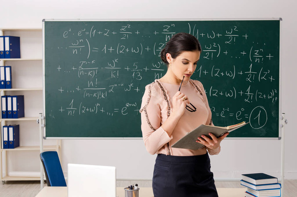 Female teacher standing in front of chalkboard    - Photo, Image