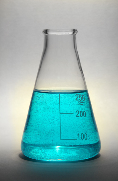 test-tube with blue liquid on grey background - Photo, image