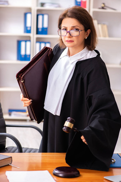 Middle-aged female doctor working in courthouse  - Photo, Image
