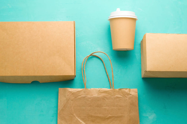 top view flat lay recyclable types of paper  packaging on a blue background, paper bag, disposable glass, cardboard box - Φωτογραφία, εικόνα