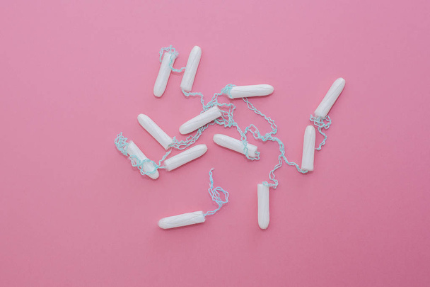 Cotton tampon on pink background. Menstrual cycle period concept - Photo, Image
