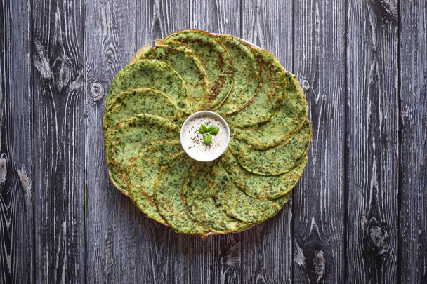 Spinach pancakes on a gray wooden table.  - Photo, Image