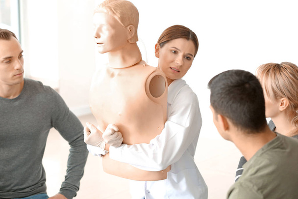 Instructor demonstrating what to do in case of choking at first aid training course - Фото, изображение