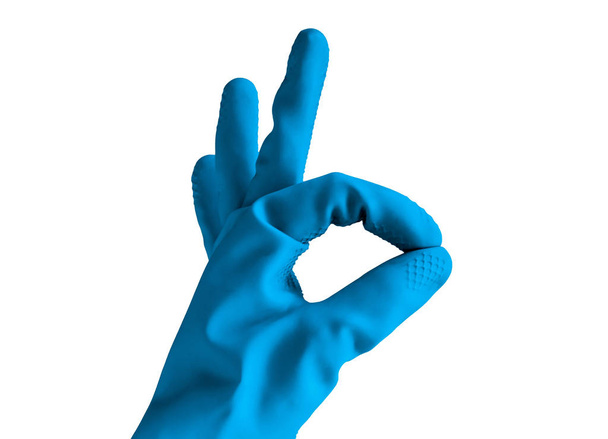 hand in rubber blue glove shows ok sign, isolated object on white background . cleaning concept - 写真・画像