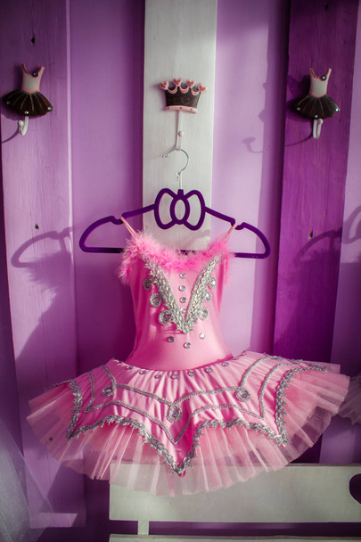 Dress for ballet, tutu, hanging on a hanger on a decorative board with hooks. - Photo, Image