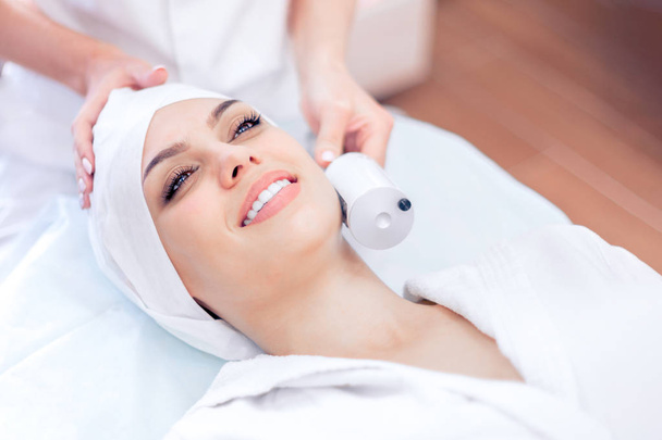Cosmetology. Apparatus massage on the face. Lifting, rejuvenation. Cosmetology clinic - Fotó, kép