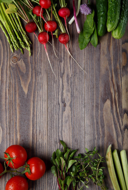 Frame of fresh organic vegetables and herbs on wooden table.  - Photo, Image