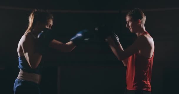 Junge erwachsene Frau beim Kickboxtraining mit ihrem Trainer. - Filmmaterial, Video
