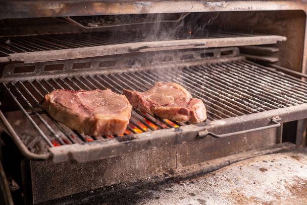 food, craft and delicious concept - cooking steak on a grill - Photo, Image