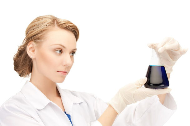 Female chemist holding bulb with chemicals - Foto, Imagen