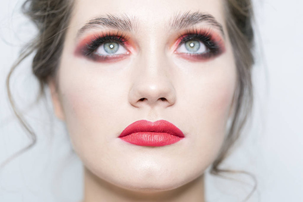 Portrait of a beautiful girl with bright makeup close-up. Look up - Fotó, kép