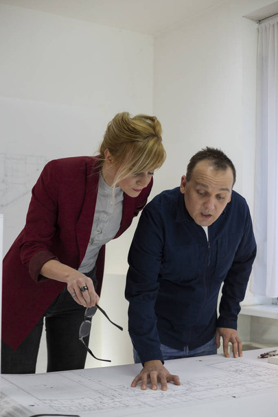 Two architects looking at a project in office - Foto, immagini