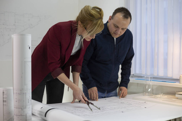 Two architects looking at a project in office - Фото, изображение