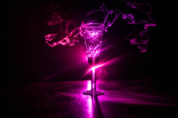暗い背景に霧とクローズ アップ ワイン グラス。煙と光の美しいガラス。選択と集中 - 写真・画像