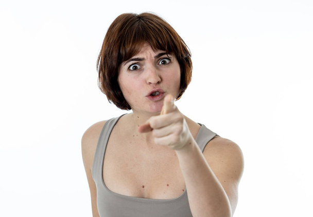 Close up of young attractive frustrated caucasian woman with angry and stressed face. Looking mad and crazy shouting and pointing at the camera. Copy space. Facial expressions and emotions. - Foto, Imagen