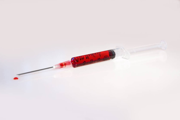 Syringe with blood on white background - Photo, Image