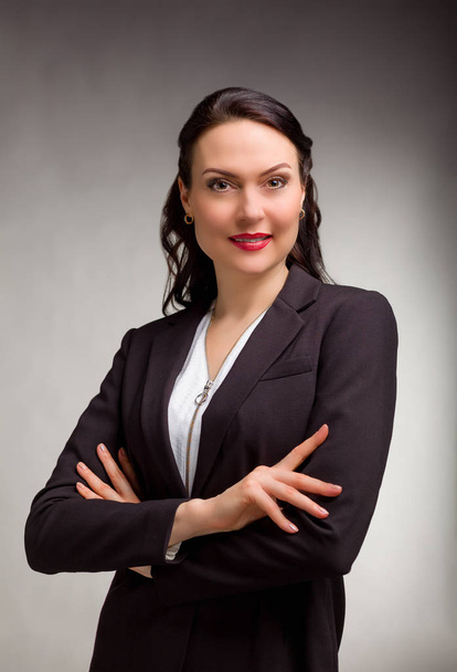 Portrait of wonderful business woman on gray background - Zdjęcie, obraz