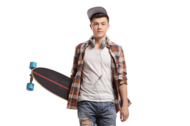 Trendy teenage skater with a longboard isolated on white background - Foto, Imagen