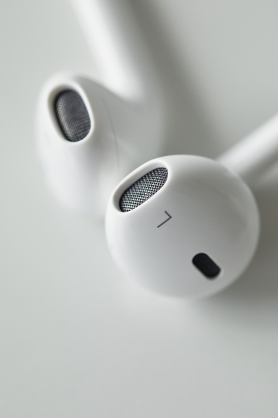 selective focus of white earphones on white surface with copy space - Zdjęcie, obraz