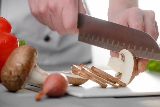 Chef cook slicing champignon mushrooms - Φωτογραφία, εικόνα