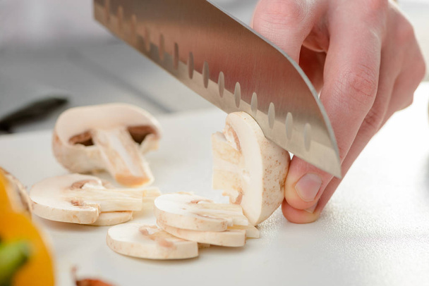 Closeup on cutting a mushroom - Фото, изображение