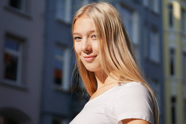 candid urban street style portrait of blond young woman - Photo, Image