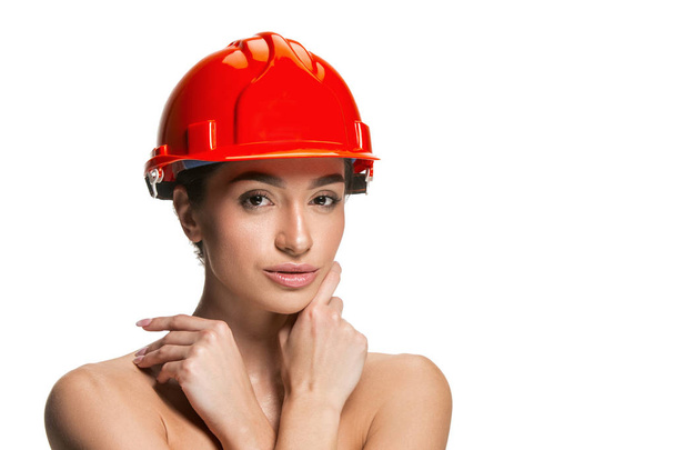 Portrait of confident female worker in orange helmet - Fotó, kép