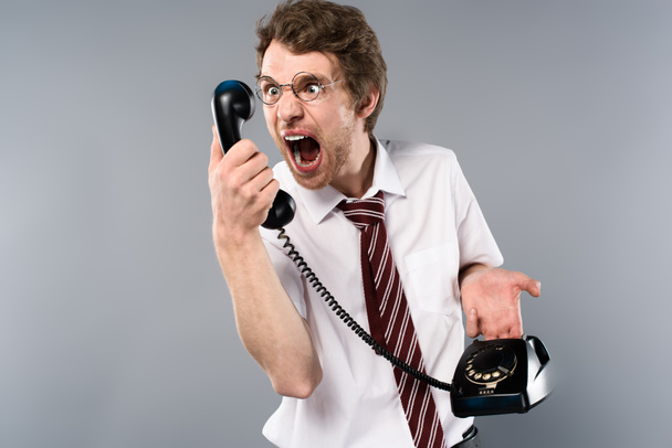 angry businessman in glasses screaming in vintage phone  - Foto, Imagen