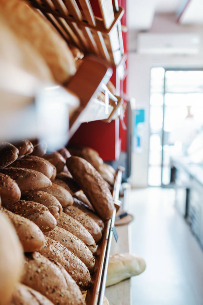 fresh baked rolls on shelve ready to eat. Bakehouse interior. - Photo, image