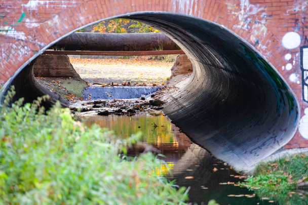 pohled zevnitř na velké odpadní potrubí pod mostem - Fotografie, Obrázek