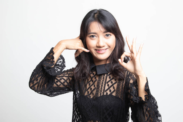 Young Asian woman show with phone gesture and OK sign. - Fotó, kép