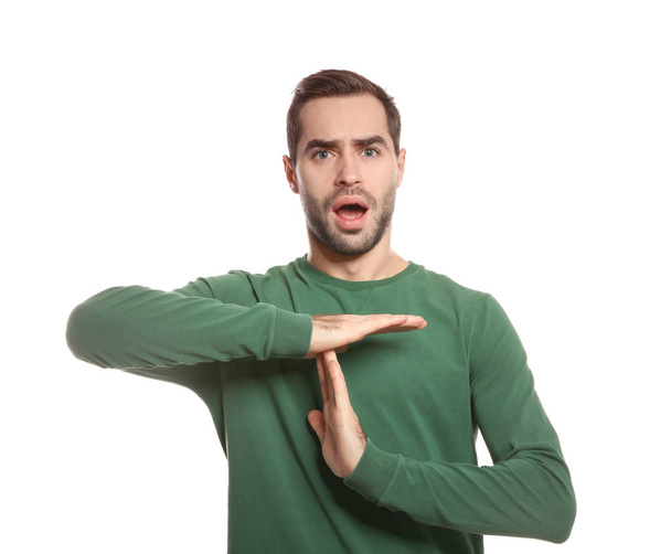 Man showing TIME OUT gesture in sign language on white background - Photo, image