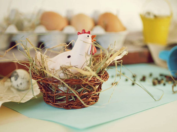 Frango e ovos de codorna, frango de brinquedo, feno, decoração de Páscoa em um fundo leve
 - Foto, Imagem