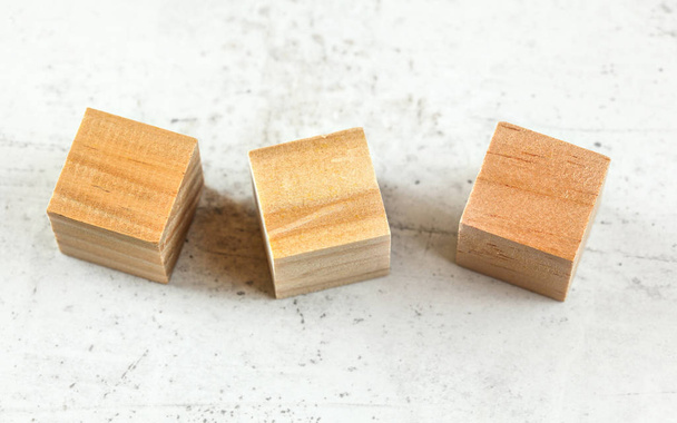 Three empty wood playing cube blocks on white board - Foto, imagen